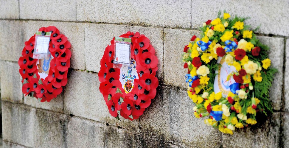 Poppy wreaths on war memorial